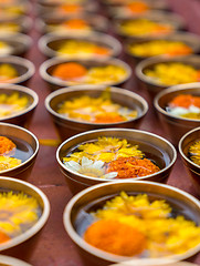 Image showing Buddhist flower offerings or gifts in bowls and rows