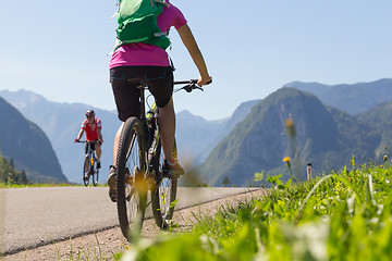 Image showing Active sporty woman riding mountain bike in nature.