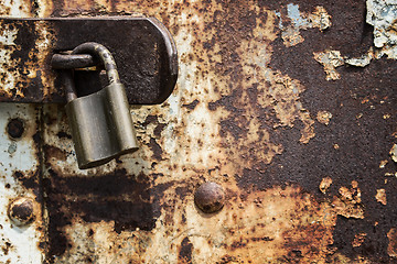 Image showing Old blue rusty metal door with lock