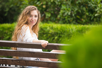 Image showing Young girl in the park looked at the frame