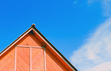 Image showing Top Of A Rustic Wooden Building Against The Sky