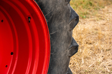 Image showing Wheels of tractor plowing field