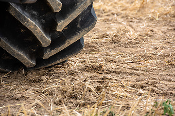 Image showing Wheels of tractor plowing field