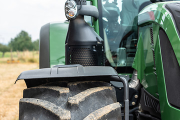 Image showing Tractor plowing field