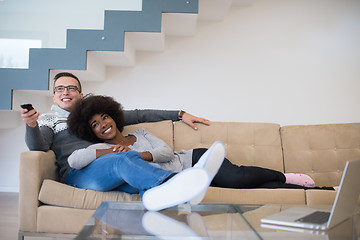 Image showing multiethnic couple relaxing at home