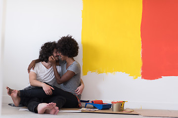 Image showing young multiethnic couple relaxing after painting