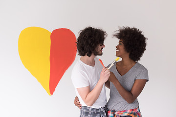 Image showing couple with painted heart on wall