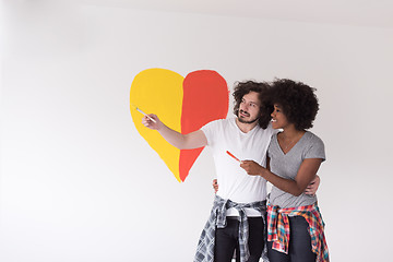 Image showing couple with painted heart on wall