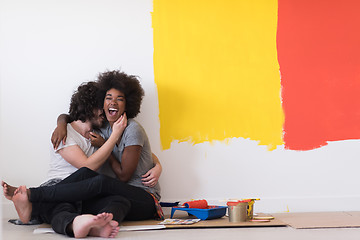 Image showing young multiethnic couple relaxing after painting