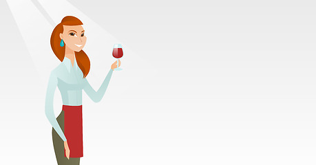 Image showing Waitress holding a glass of wine in hand.