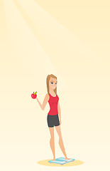 Image showing Woman standing on scale and holding apple in hand.