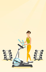 Image showing Woman exercising on elliptical trainer.