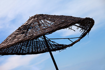 Image showing Old sunshade with hole and blue sky