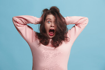 Image showing The squint eyed woman with weird expression isolated on blue