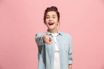 Image showing The happy business woman point you and want you, half length closeup portrait on pink background.