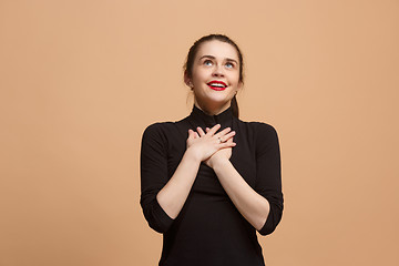 Image showing The happy business woman standing and smiling against pastel background.