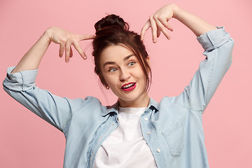 Image showing The squint eyed woman with weird expression isolated on pink