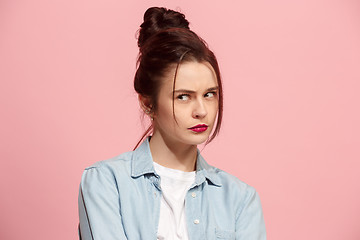 Image showing Suspiciont. Doubtful pensive woman with thoughtful expression making choice against pink background