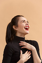 Image showing The happy business woman standing and smiling against pastel background.