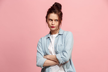 Image showing Suspiciont. Doubtful pensive woman with thoughtful expression making choice against pink background