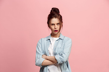 Image showing Suspiciont. Doubtful pensive woman with thoughtful expression making choice against pink background