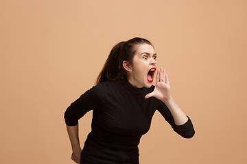 Image showing The young emotional angry woman screaming on pastel studio background