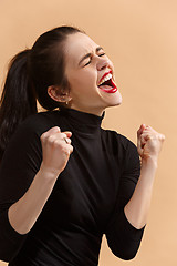 Image showing Winning success woman happy ecstatic celebrating being a winner. Dynamic energetic image of female model