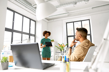 Image showing woman showing tablet pc to creative team at office