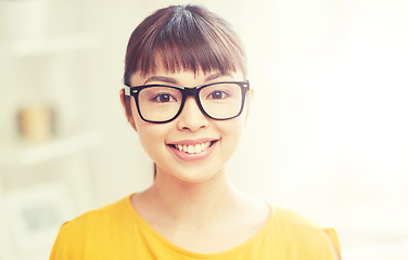 Image showing happy asian young woman in glasses at home