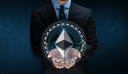 Image showing close up of businessman with ethereum over space