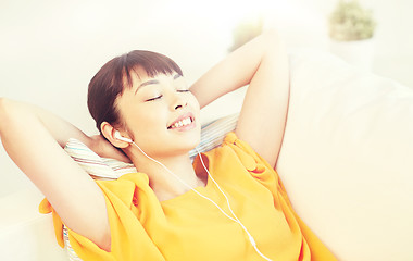 Image showing happy asian woman with earphones listening music