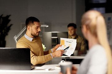 Image showing colleagues discussing project at nigh office