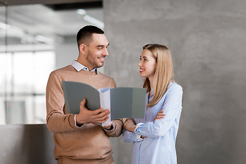 Image showing man and woman with folders at office stairs