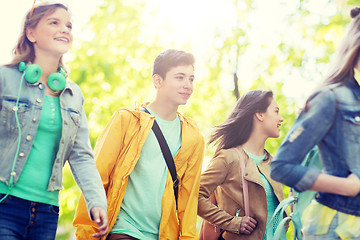 Image showing group of happy teenage students walking outdoors