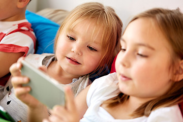 Image showing little kids with smartphone in bed at home