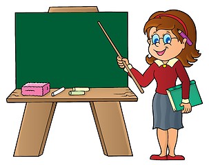 Image showing Woman teacher standing by schoolboard