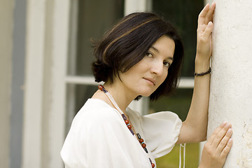 Image showing woman standing near white column