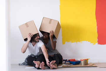 Image showing young multiethnic couple playing with cardboard boxes
