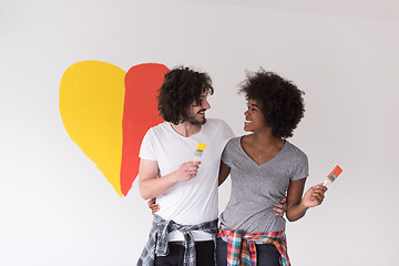 Image showing couple with painted heart on wall