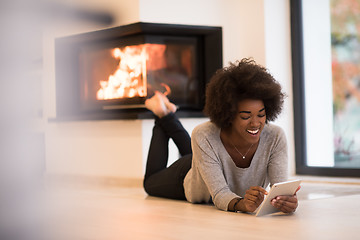 Image showing black women using tablet computer on the floor