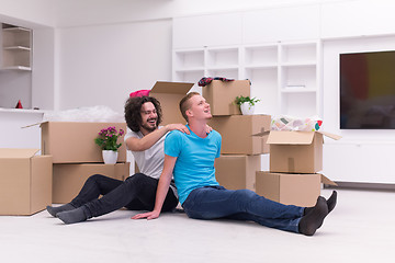 Image showing young  gay couple moving  in new house