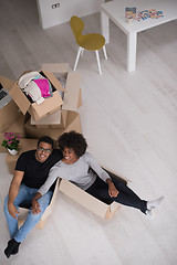 Image showing African American couple  playing with packing material