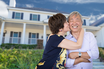 Image showing Happy Chinese Senior Adult Couple Kissing In Front Of Custom Hou