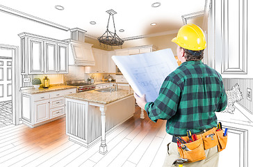 Image showing Male Contractor with Hard Hat and Plans Looking At Custom Kitche