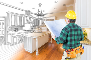 Image showing Male Contractor with Hard Hat and Plans Looking At Custom Kitche