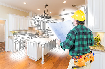 Image showing Male Contractor with Hard Hat and Plans Looking At Custom Kitche