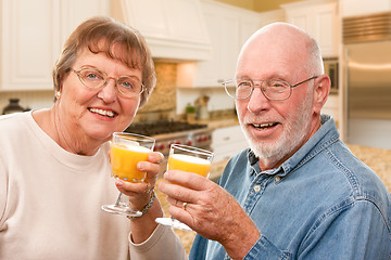 Image showing Happy Senior Couple with Glasses of Orange Juice