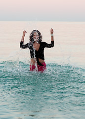 Image showing woman in wet clothes splashing