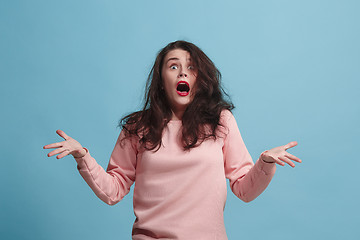 Image showing The squint eyed woman with weird expression isolated on blue