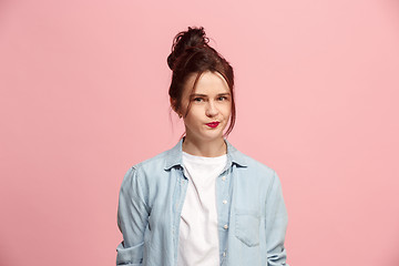 Image showing Suspiciont. Doubtful pensive woman with thoughtful expression making choice against pink background